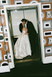 Bride Wearing Simple Aline Wedding Dress Called Selena By Maggie Sottero Kissing Groom In An Elevator