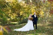 Bride with Groom at Their Outdoor Fall Wedding Wearing the Wedding Dress Called Savannah by Maggie Sottero.