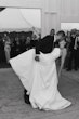 Bride Wearing Sexy Strapless Wedding Dress Called Zelda By Rebecca Ingram Kissing Groom At The Reception