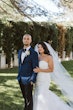 Bride wearing Hattie Lynette wedding dress by Rebecca Ingram standing with her husband