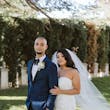Bride wearing Hattie Lynette wedding dress by Rebecca Ingram standing with her husband