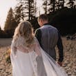 Bride wearing Summer wedding dress by Maggie Sottero walking with her husband