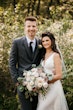 Bride with groom wearing satin sheath wedding dress.