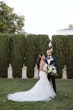 Bride wearing Hattie Lynette wedding dress by Rebecca Ingram with her husband