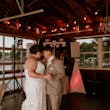 Bride wearing Tuscany Marie wedding dress by Maggie Sottero dancing with her husband