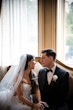 Bride wearing Barcelona by Sottero and Midgley sitting talking to her husband