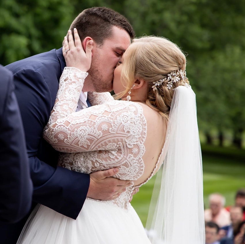 Bride Kissing Groom Wearing Bridal Gown Called Mallory Dawn by Maggie Sottero