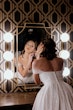 Bride wearing Anniston by Maggie Sottero looking in the mirror