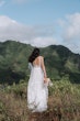 Bride in Winter wedding dress by Maggie Sottero on top of mountain