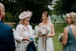 Bride wearing Lorraine by Rebecca Ingram talking to loved ones