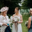 Bride wearing Lorraine by Rebecca Ingram talking to loved ones