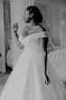 Bride wearing Tatiana wedding dress by Maggie Sottero putting on perfume