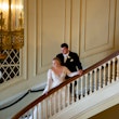 Bride and Groom on Grand Staircase Wearing Bridal Dress Called Mallory Dawn by Maggie Sottero