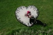 Bride Wearing Gothic Black Lace Wedding Dress Called Tristyn By Maggie Sottero With Dress Shaped As A Heart Holding Groom