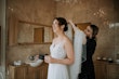 Bride wearing Lorraine by Rebecca Ingram getting her hair done