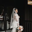 Bride Wearing Lacey Sheath Long Sleeve Wedding Dress Called Francesca By Maggie Sottero Showing Back Veil