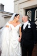 Bride wearing Ekaterina by Maggie Sottero holding hands with her husband