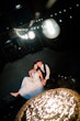 Bride Wearing Ballerina-inspired Romantic Wedding Dress Called Fairbanks By Maggie Sottero And Groom Sitting Around A Fire