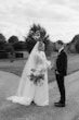 Bride wearing Yates wedding dress by Maggie Sottero with her husband