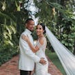 Bride with groom wearing glamorous mermaid wedding dress