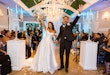 Bride wearing Zinaida by Maggie Sottero celebrating with her husband in the aisle