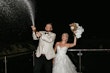 Bride wearing Indiana by Maggie Sottero and her husband spraying alcohol