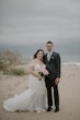 Bride wearing Frederique wedding gown by Maggie Sottero with groom