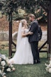 Bride Wearing Lace Aline Bridal Gown Called Harlem By Maggie Sottero Holding Groom At The Altar