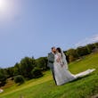 Bride Wearing Lace Long Sleeve Aline Wedding Dress Called Winter By Maggie Sottero In A Field Kissing Groom