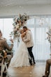 Bride wearing Indiana by Maggie Sottero kissing her husband at their ceremony