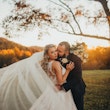 Bride with groom wearing a plus size ballgown wedding dress.