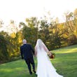 Groom Holding Hands with Bride in Wedding Dress Called Savannah by Maggie Sottero.