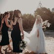 Bride Wearing Off-The-Shoulder Lace Wedding Dress Called Carson By Sottero And Midgley Walking On The Beach With Bridesmaids