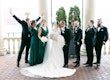 Bride wearing Ekaterina by Maggie Sottero kissing her husband in front of their wedding party