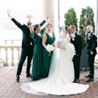 Bride wearing Ekaterina by Maggie Sottero kissing her husband in front of their wedding party
