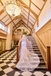Bride wearing Saige by Maggie Sottero walking up the stairs