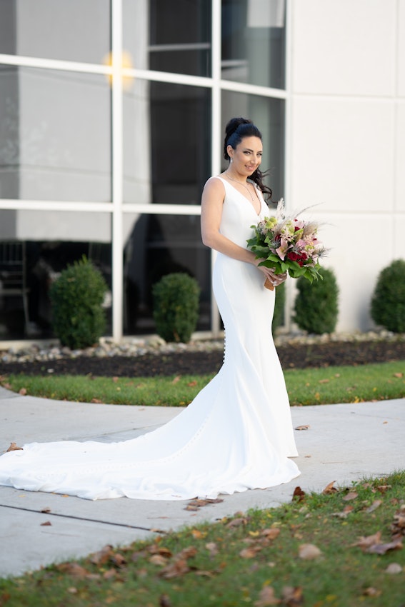 Bride wearing simple fit and flare crepe wedding dress