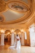 Real Bride Wearing A Vintage White Wedding Dress Named Veronique by Maggie Sottero With Veil And Red Roses