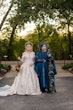 Bride Wearing Jaquard Wedding Dress Called Derrick Marie By Maggie Sottero With Her Partner Who Is Holding A Staff