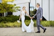 Bride wearing Audrina by Maggie Sottero holding hands with her husband