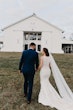 Bride and Groom Walk Together. Bride Wearing Halter Lace Detailer Fit And Flare Wedding Dress Called Kevyn By Sottero And Midgley And A Long Veil