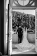 Bride wearing Cecilia by Rebecca Ingram on a balcony with her husband