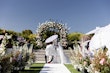 Bride wearing Tatiana wedding dress by Maggie Sottero during their wedding ceremony