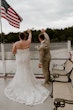 Bride wearing Tuscany Marie wedding dress by Maggie Sottero waving with her husband