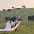 Bride Wearing Sparkly Fit And Flare Wedding Dress Called Anniston Lane By Maggie Sottero Kissing Groom In A Field With Cows