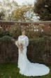 Bride Wearing Crepe Wedding Dress Called Dionne By Rebecca Ingram Holding Boho Bouquet