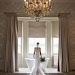 Bride Wearing Simple Off-the-shoulder Wedding Dress Called Josie By Rebecca Ingram In A Bathroom
