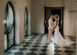 Bride wearing Tuscany Lynette by Maggie Sottero holding hands with her husband