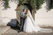 Bride wearing Iris wedding dress by Rebecca Ingram kissing her husband