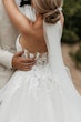 Bride wearing Indiana by Maggie Sottero looking up at her husband